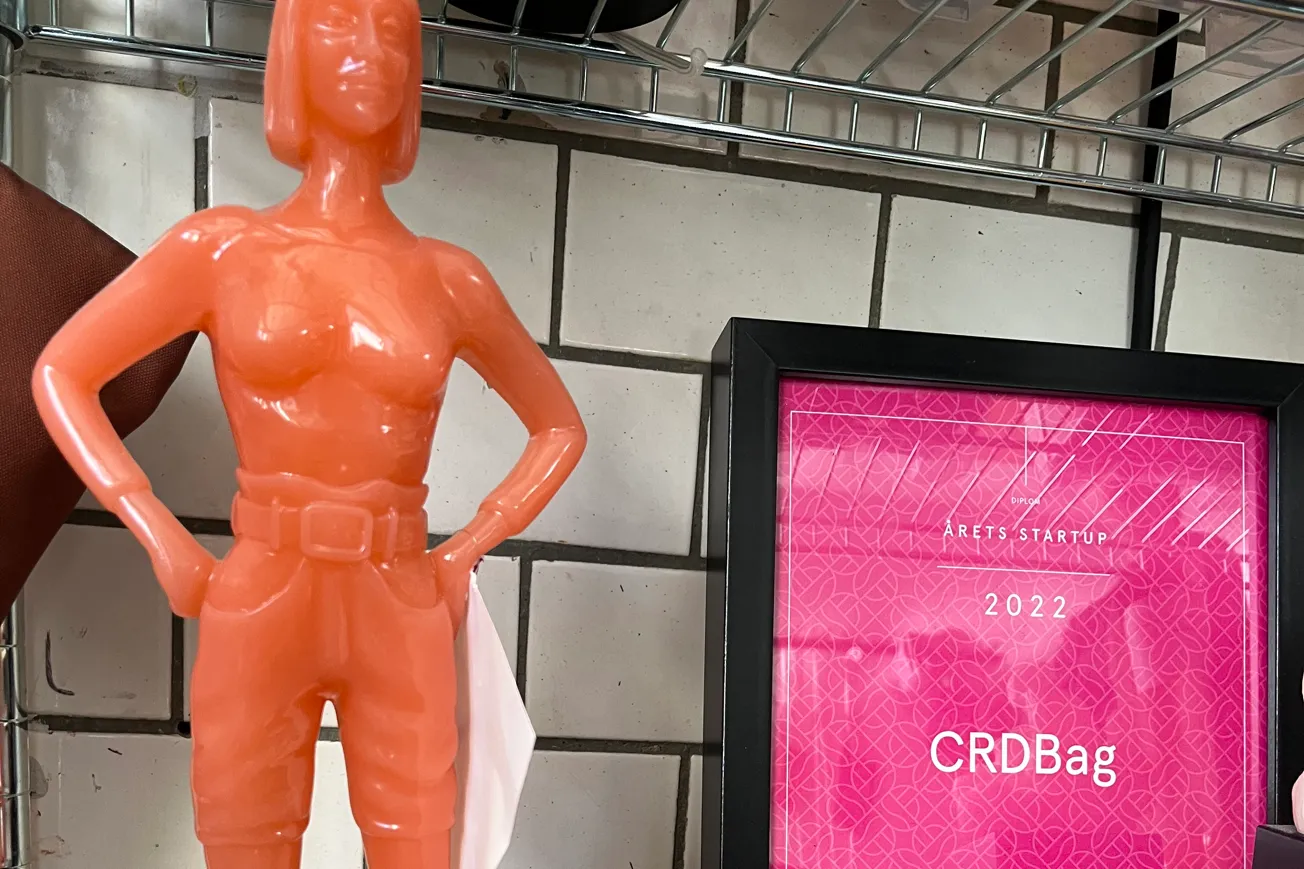 En plastfigur föreställande en kvinna som står på en hylla.