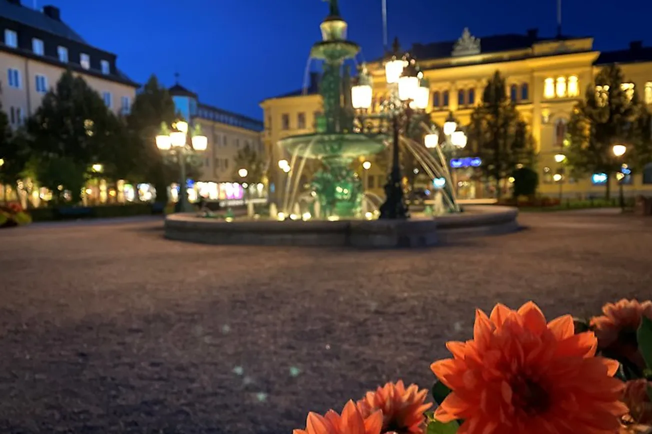 Fontänen Vängåvan i parken med blommor i förgrunden.